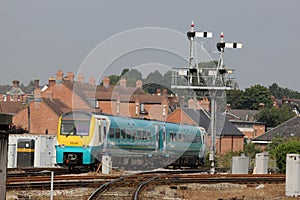 Train passing signal gantry at Shrewsbury station