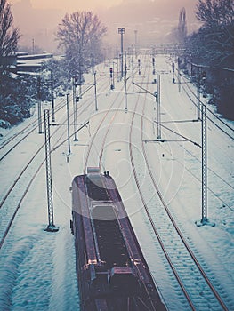 Train passing through the snow covered train tracks