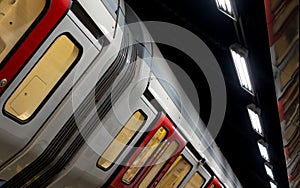 Train on the platform at Euston Square Underground Station, London UK, showing reflection of train on ceiling above.