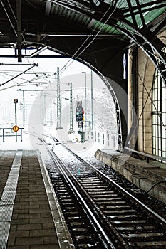 Train platforme with semaphore on snowy winter day