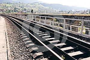 Train rails in country landscape. Railroad tracks at sunset time. Local travel concept