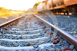 The train rails in the morning when the sun shines.