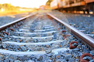 The train rails in the morning when the sun shines.