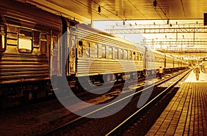 Train at railway station, sunset orange light