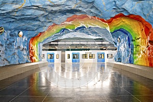 Train at rainbow painted subway of famous underground Stadion station