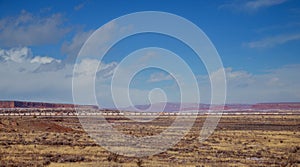 Train rolls across desert in the middle of the vast desert in Arizona