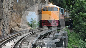 Train run on track at hellfire pass mountain station in Kanchanaburi, Thailand