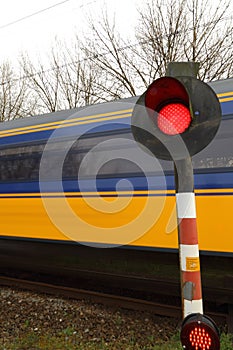 Train rushing past railway crossing