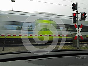 Train rushing by at railroad crossing in Germany