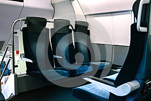 The train seats are blue. Empty seats in a modern and comfortable train. Convenient passenger transport for travel and business