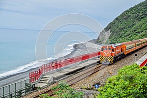 A train speeding by the ocean coast