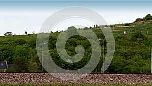 Train speeding past fields