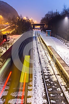 Train Speeding Through Snow Covered Station