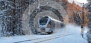 Train speeding on a snowy winter day