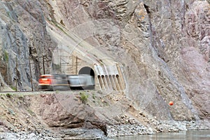 A train speeds out of a tunnel along the Thompson River in British Columbia, Canada