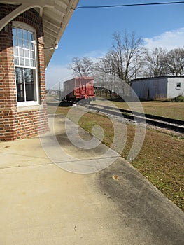 Train station with caboose in distance