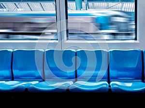 Train station and empty seats commuter with blue color interior inside in the subway train