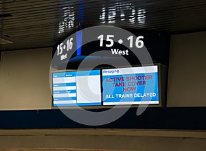 Train station message sign indicating that trains are delayed due to an active shooter. photo