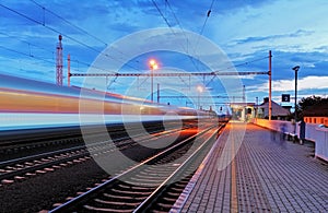 Train station in motion blur at night, railroad