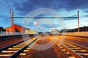 Train station in motion blur at night, railroad