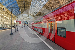 Train station with red cars of the railway express. Sunny Travel concept.