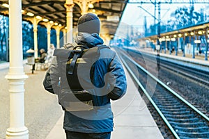 Train Station in Sopot, Poland, Europe. Attractive man waiting at the train station. Thinking about trip, with backpack. Travel