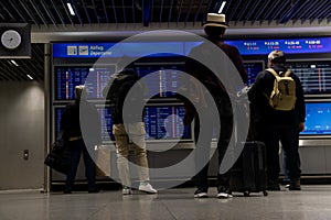 Train station terminal in Brussels Midi Station, passengers and travelers gather affront of info screen