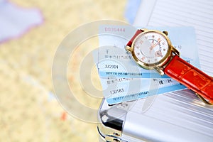 Train ticket and watch on the suitcase