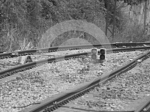 train tracks with black and white traffic light