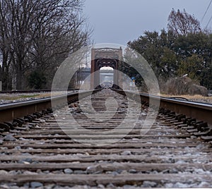 Train tracks converging into the distance