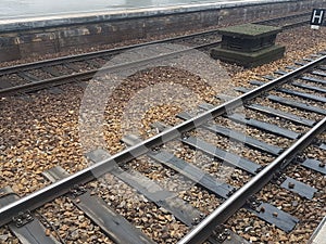 Train tracks and dark stones photo