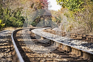 Train tracks disappearing into a rural autumn landscape photo