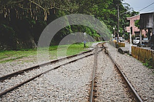 Train tracks on gravel, two of railways tracks merge in a rural scene background, concept of journey