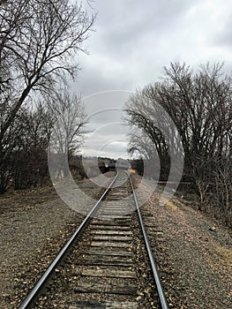 Train tracks leading to the Big Sioux River in Sioux Falls South Dakota with views of wildlife, ruins, park paths, train track