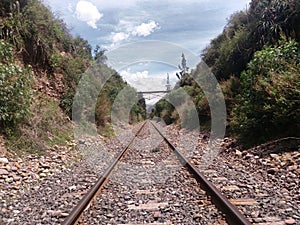 train tracks in the middle of hills photo