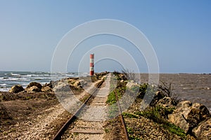 Train tracks between river and ocean photo