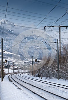 Train tracks in the Swiss countryside covered in snow in deep winter