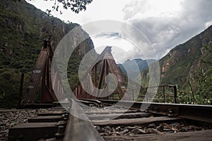 Train tracks towards Machu Picchu Inca ruins in Peru
