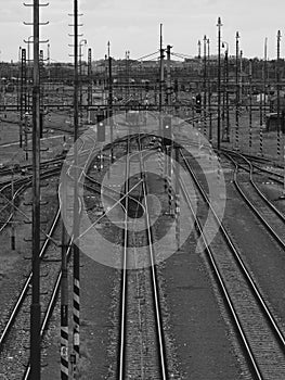 Train tracks and traffic lights in black and white