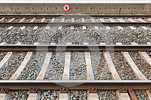 Train tracks at train station with crossing forbidden sign in Ra