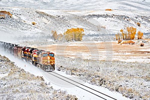 Train transporting tank cars. Season changing autumn to winter.