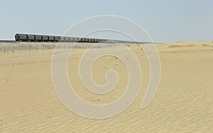 Train traveling through a desert