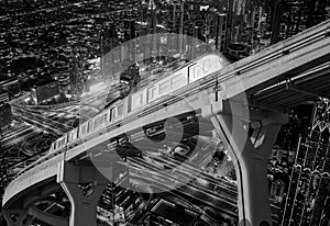 the train travels on a monorail through Dubai at night