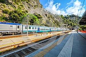 A train travels through the Monterosso al Mare train station on the coast of Cinque Terre, Italy photo