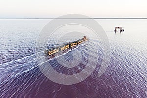 train travels from water. Mined salt in Lake Burlin. Altai. Russia. Bursolith. Old train rides on the railway laid in the water