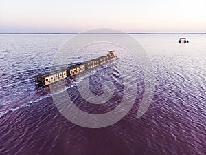 train travels from water. Mined salt in Lake Burlin. Altai. Russia. Bursolith. Old train rides on the railway laid in the water