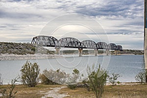 Train trestle over Lake Amistad in Val Verde county Texas photo