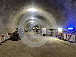 Train tunnel construction with barriers and fresh concrete walls