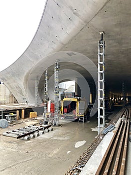 Train tunnel construction with scaffolding against fresh concrete walls