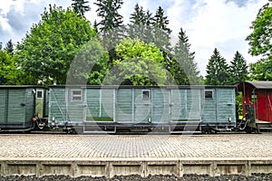Train wagon with cargo on a railway at a station